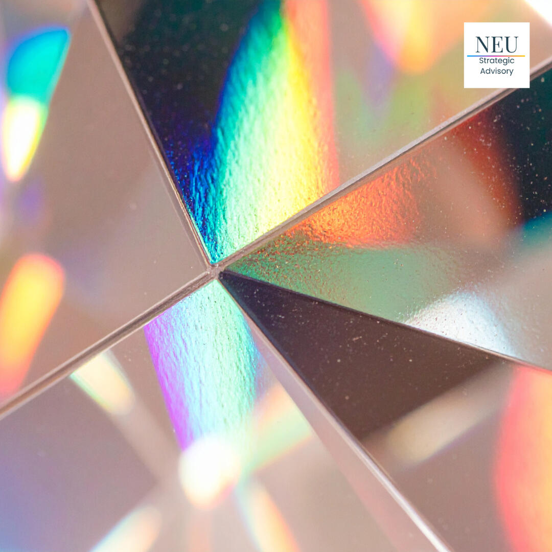 A close-up image of abstract glass reflecting rainbow light, with the logo for NEU Strategic Advisory, a healthcare and luxury brand marketing agency, in the top right corner.
